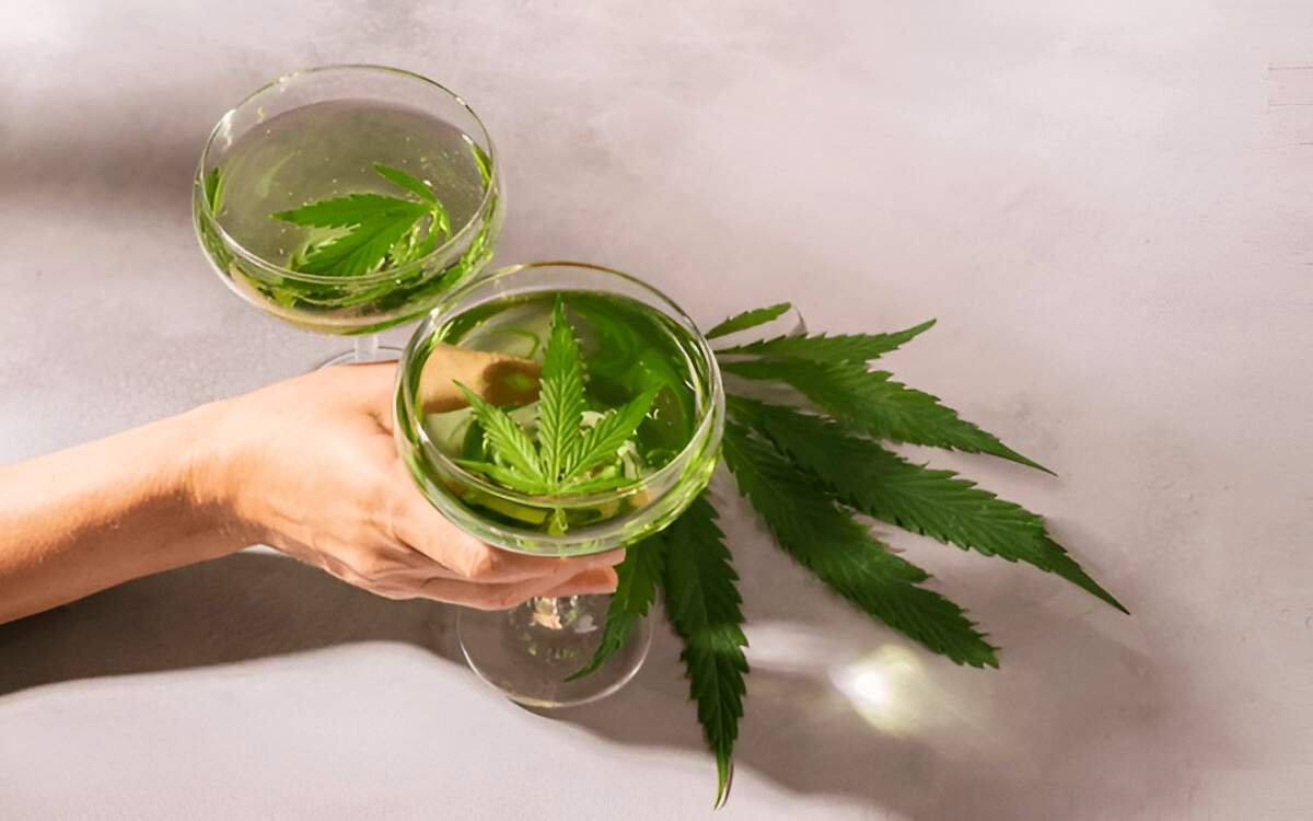 Image of Delta 9 drink in a glass with some hemp plant leaves on top